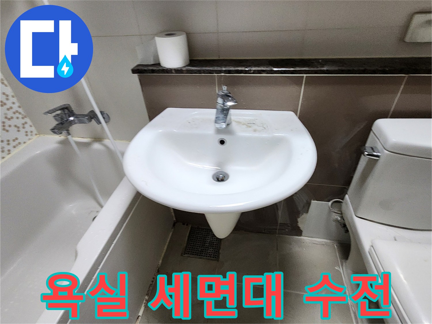 세면대에 설치된 은색 수도꼭지와 주변 타일 이미지입니다.