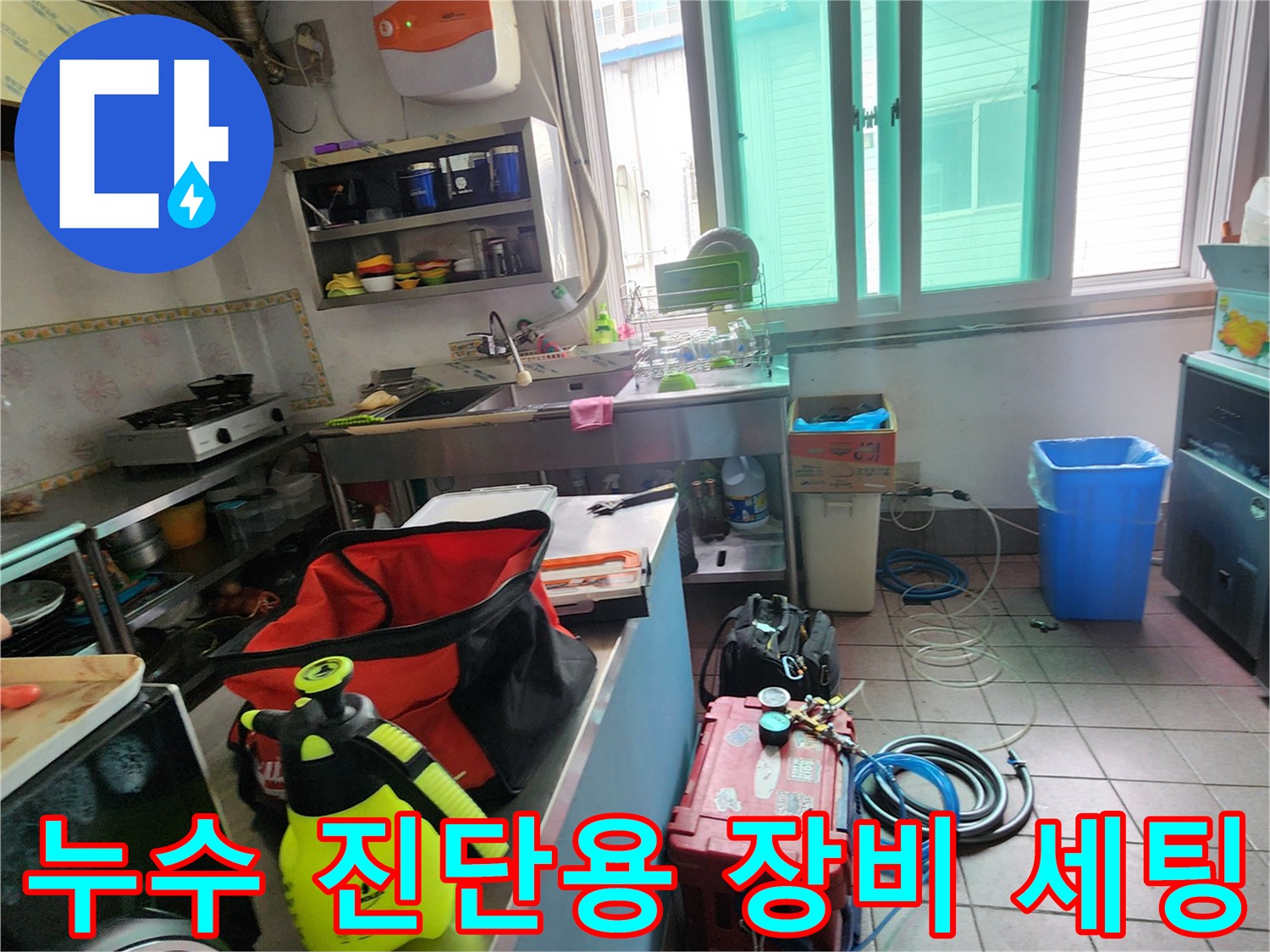 바닥에 놓인 누수 탐지용 가스 장비와 공구함 및 압력 측정 도구