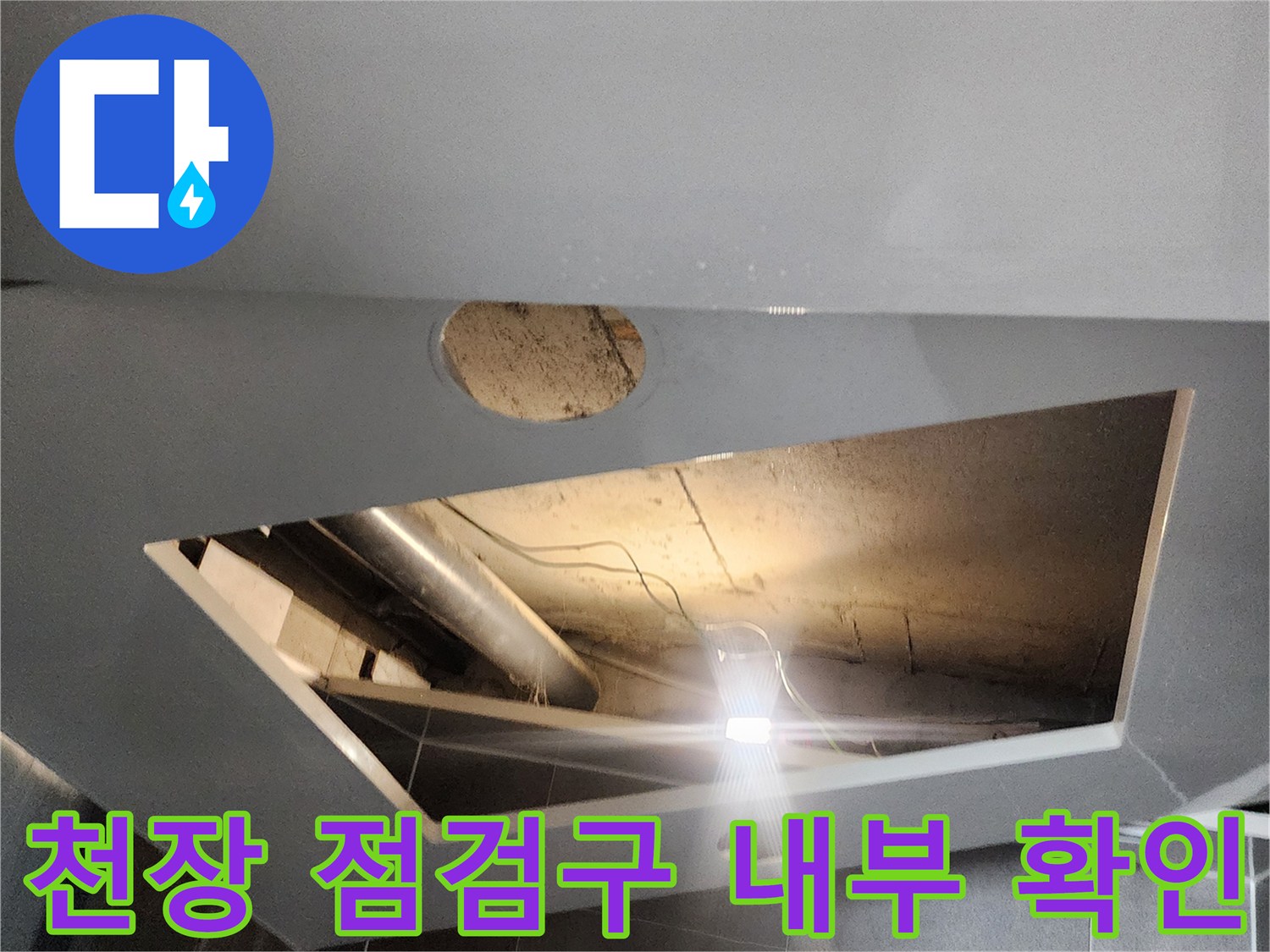 점검구 안쪽으로 보이는 천장 구조물과 배관