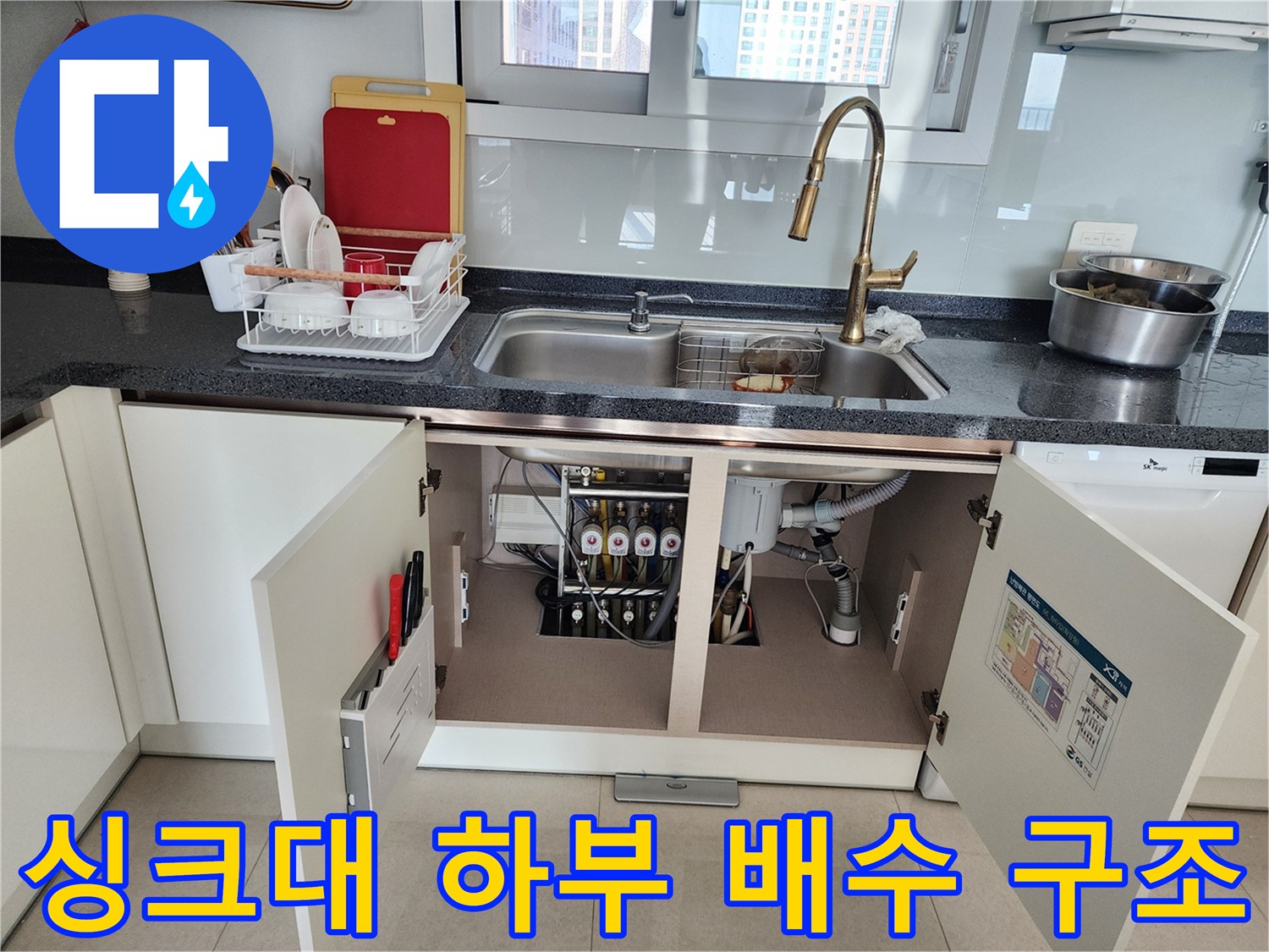 싱크대 하부장 내부 배수관과 급수 밸브의 상세 모습
