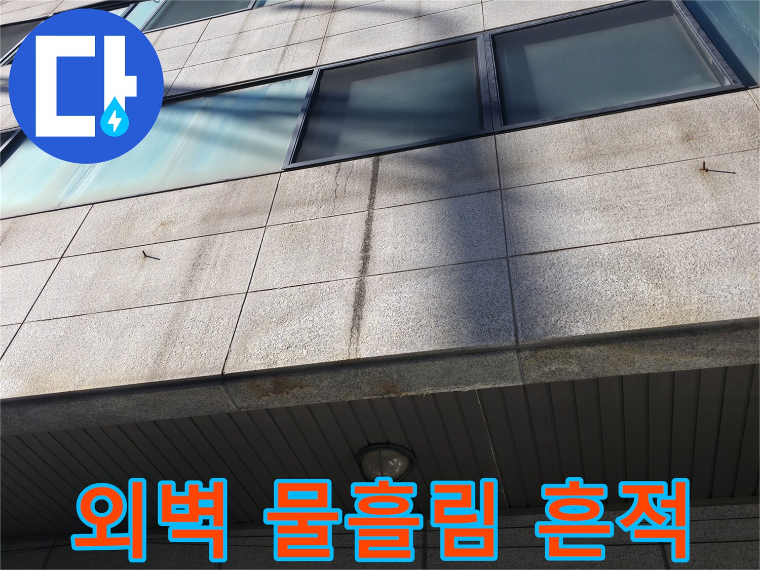 건물 외벽 석재 패널에 나타난 짙은 누수 오염 및 수분 침투 흔적