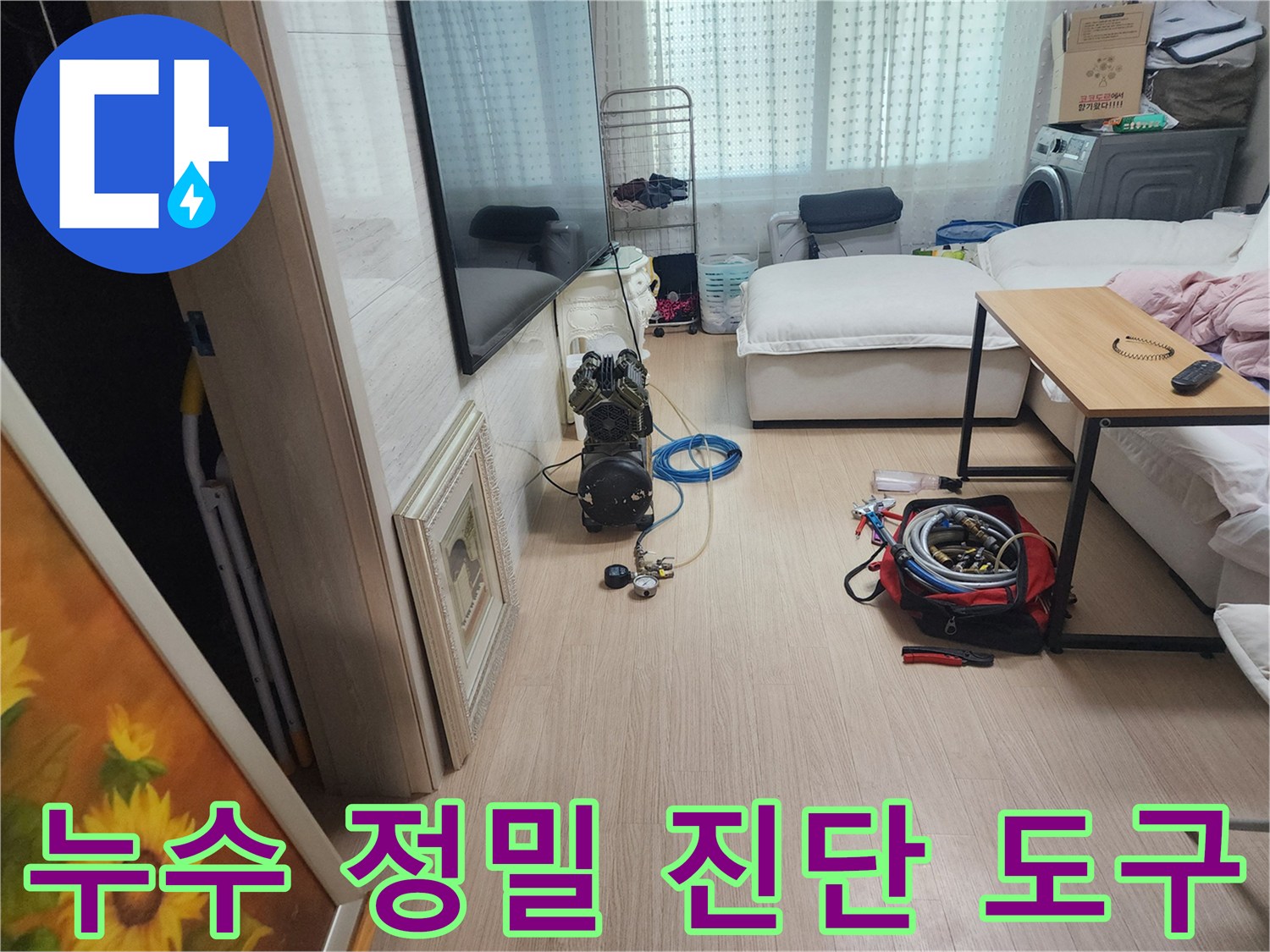 거실 바닥에 준비된 누수 탐지를 위한 각종 호스와 장비