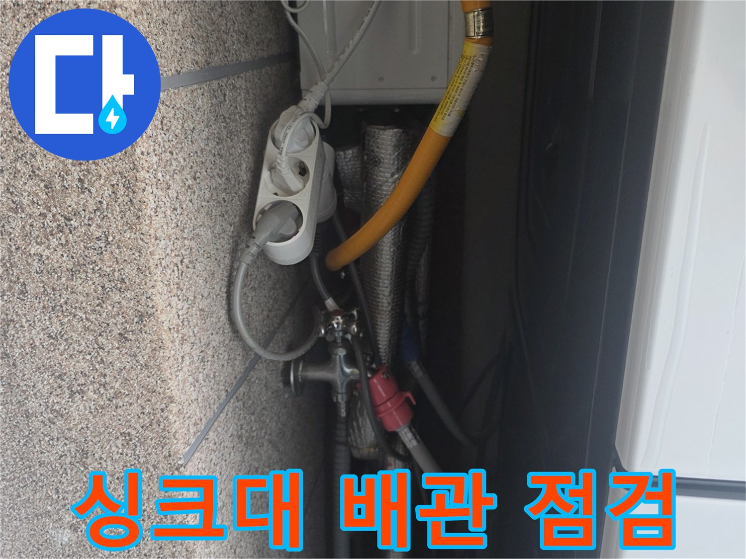 주방 싱크대 하부장 내부의 노후된 배수 호스와 연결 부위 상태