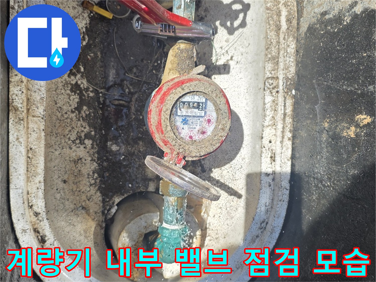 수도 계량기와 붉은색 제어 핸들 밸브