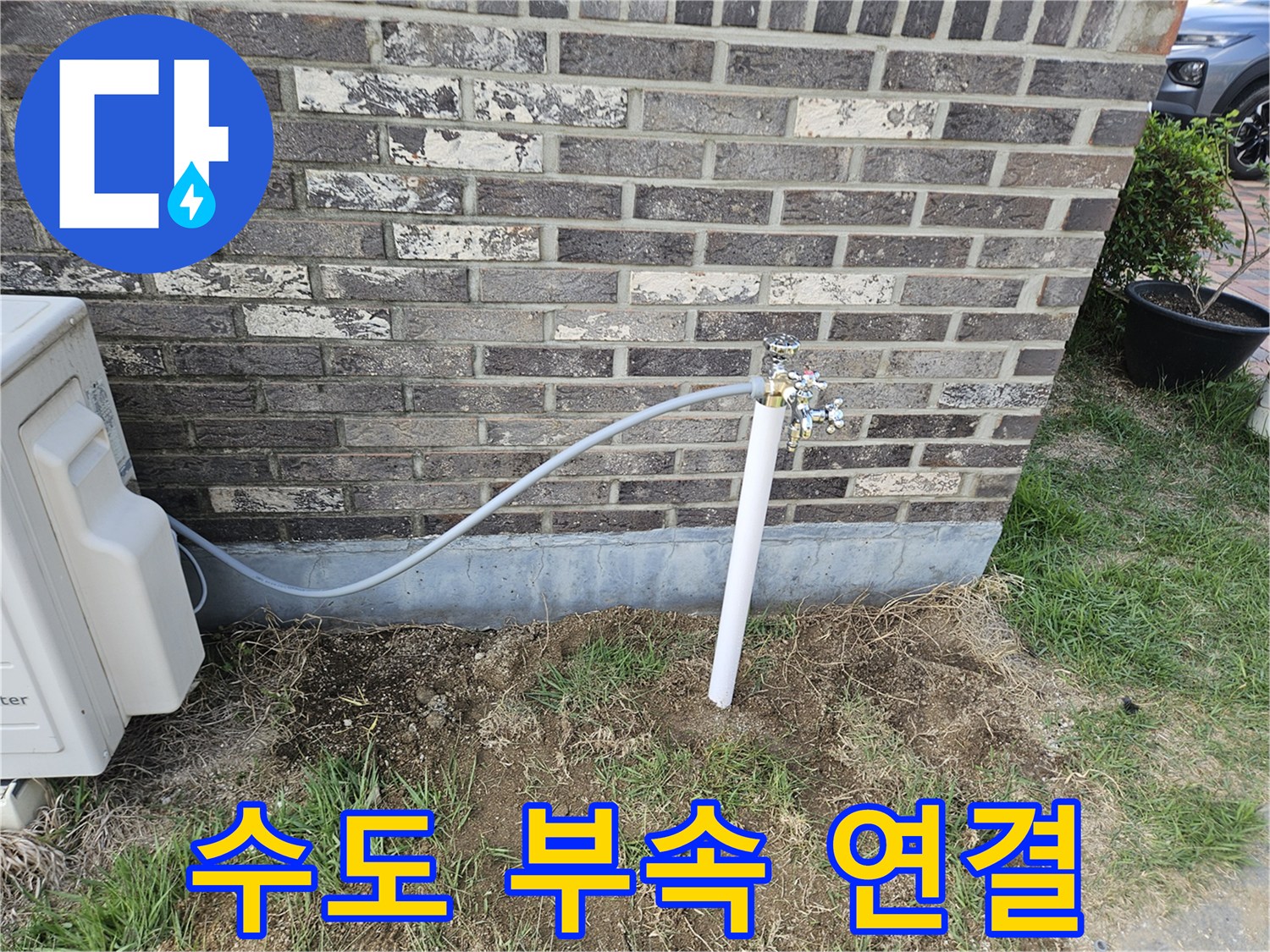 외부 벽면에 설치된 금속 수전과 플라스틱 배관