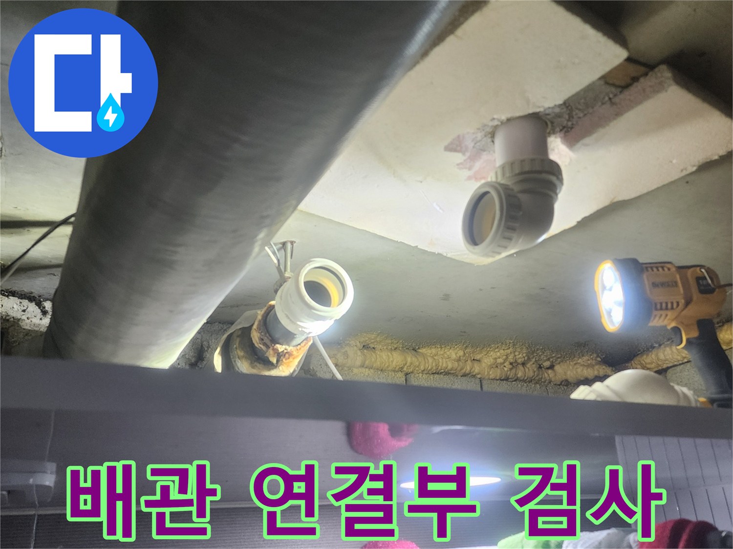 누수-전문가가-어두운-천장-속-배관의-연결-부위를-정밀하게-검사하여-누수-지점을-확인하는-모습