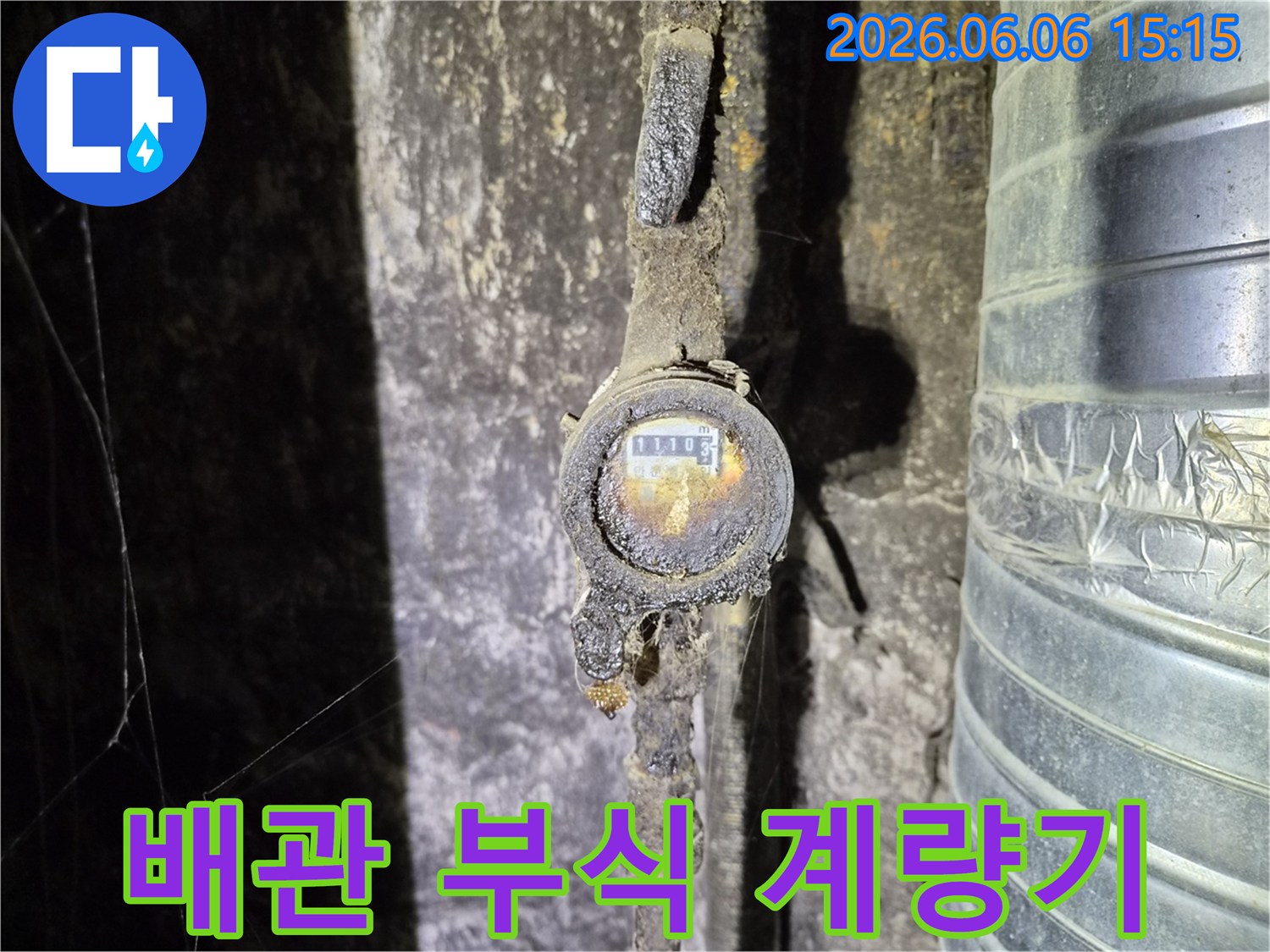 오래된 건물의 지하에서 발견된-심하게 부식된 수도 계량기의 모습으로-누수 발생의 주요 원인 중 하나인-노후 배관 문제를 명확히 보여줍니다