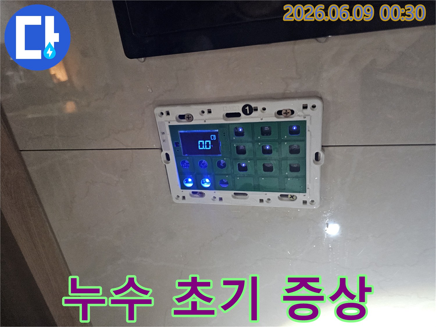 욕실 벽에 설치된 스마트패드 주변에 물기가 스며든-누수 초기 증상을 보여주는 사진