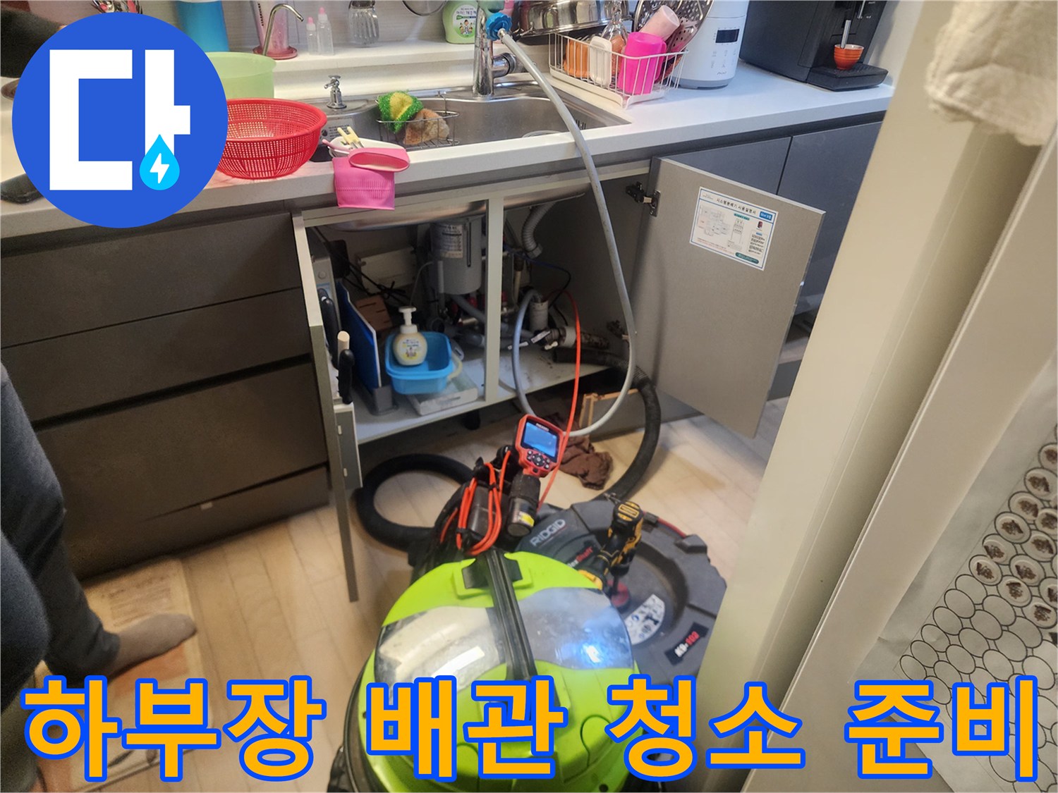 싱크대 하단 공간에 배치된 배관 스케일링 및 흡입용 전문 장비