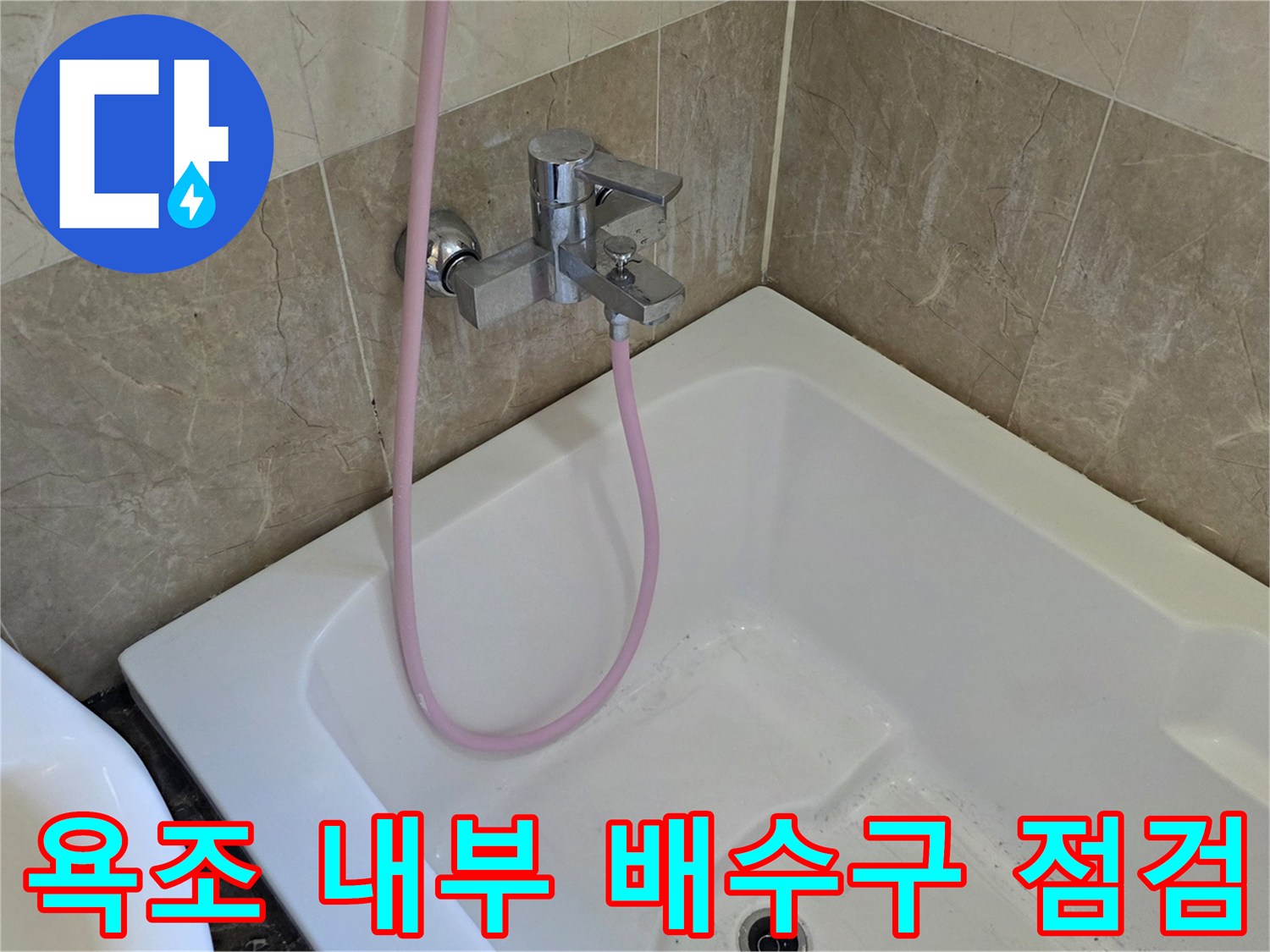 욕조 하단 배수구와 벽면 타일 경계 부위 사진입니다.
