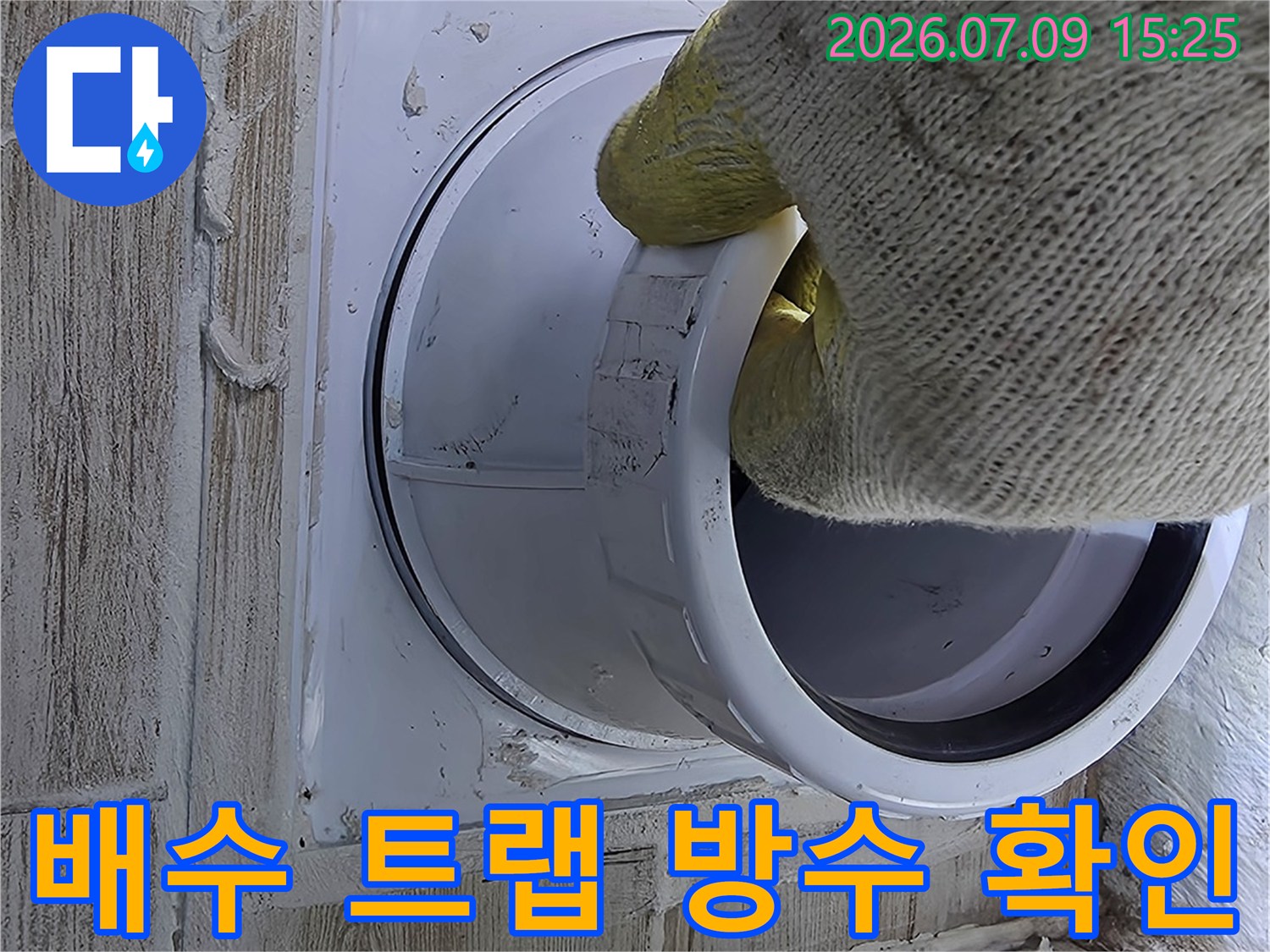 작업자가 세탁기 배출용 배수 구조를 점검하며 누수 여부를 파악하는 모습
