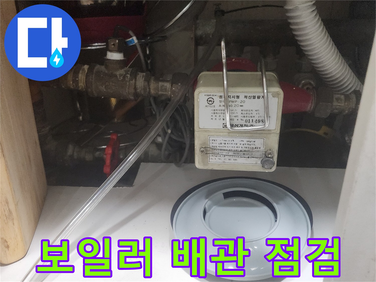 보일러실 내부의 배관 연결 부위와 압력계가 설치된 상태입니다.