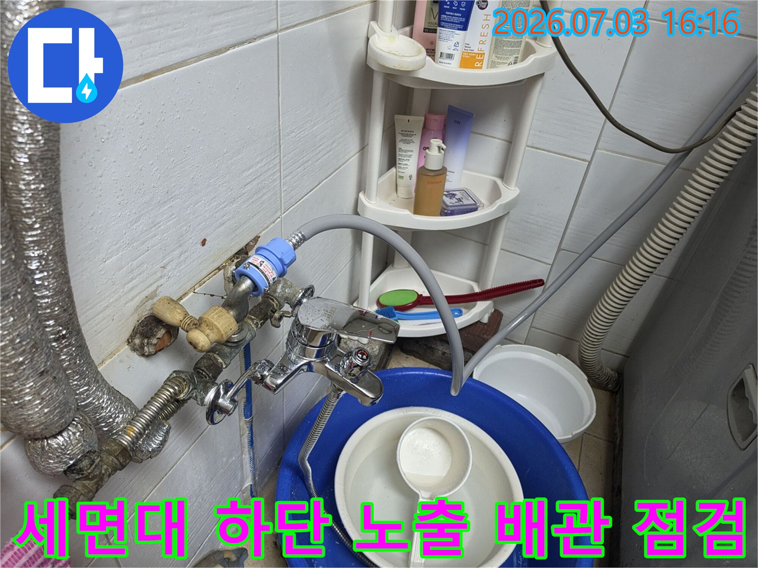 세면대 밑쪽으로 연결된 배관들과 부속품들을 정밀하게 검사하는 현장