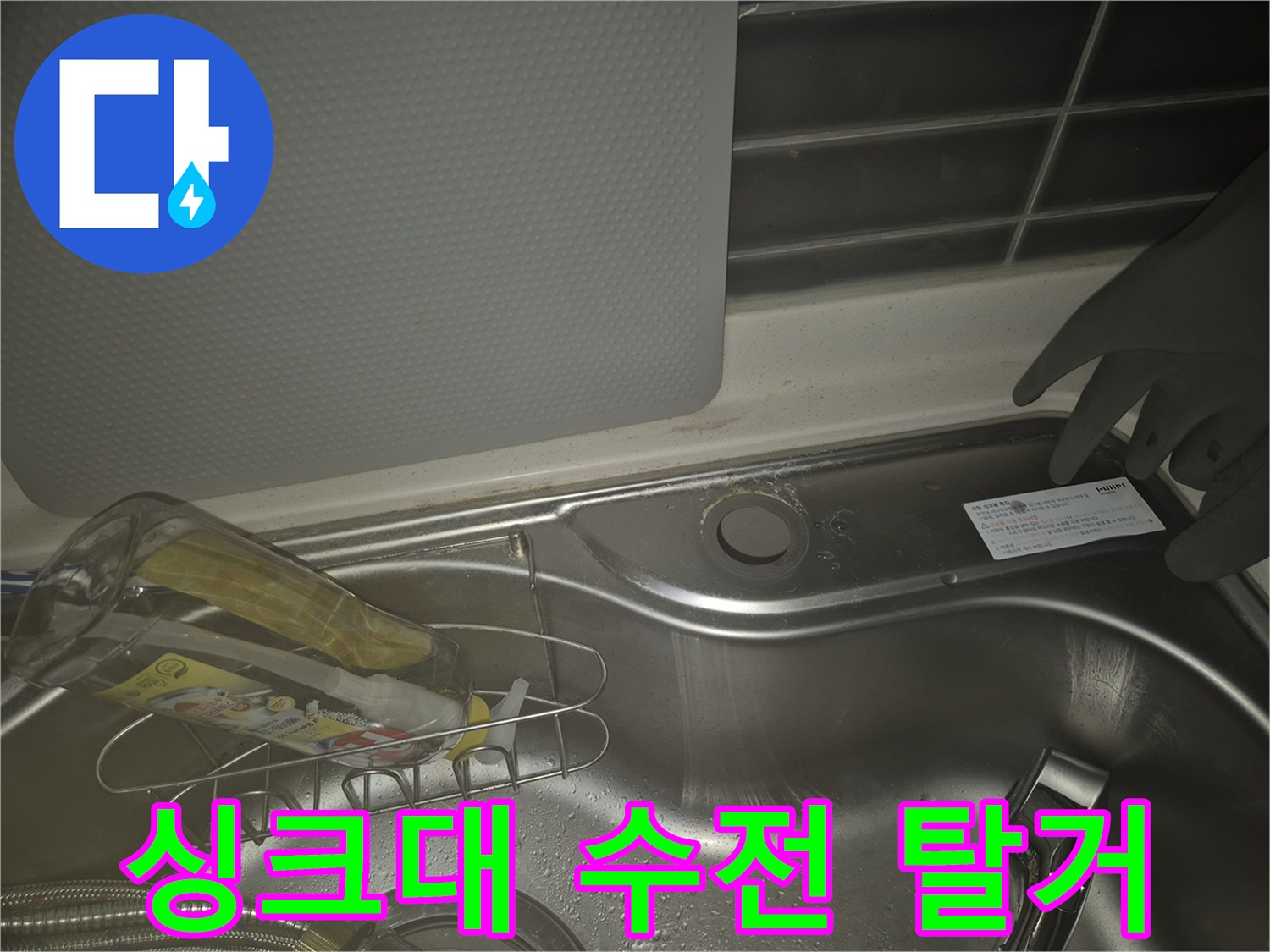 작업자가 싱크대 수전을 분리하여 놓아둔 사진입니다.