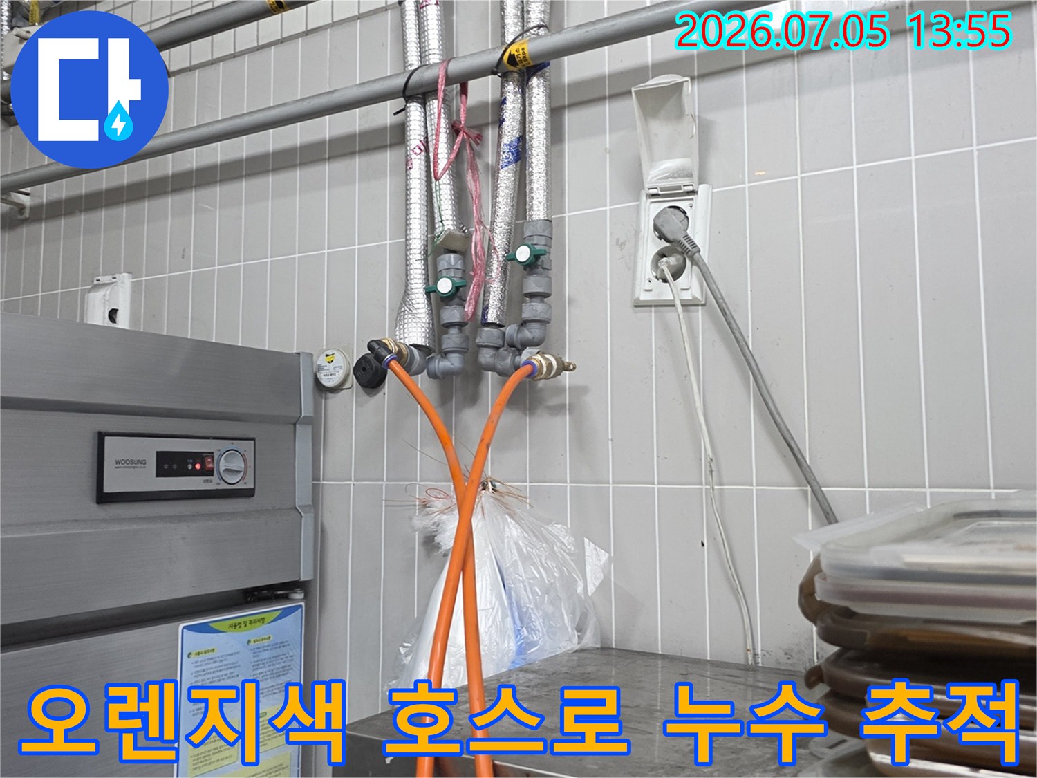 누수 지점을 찾기 위해 배관에 연결된 오렌지색 트레이서 라인과 점검 장비