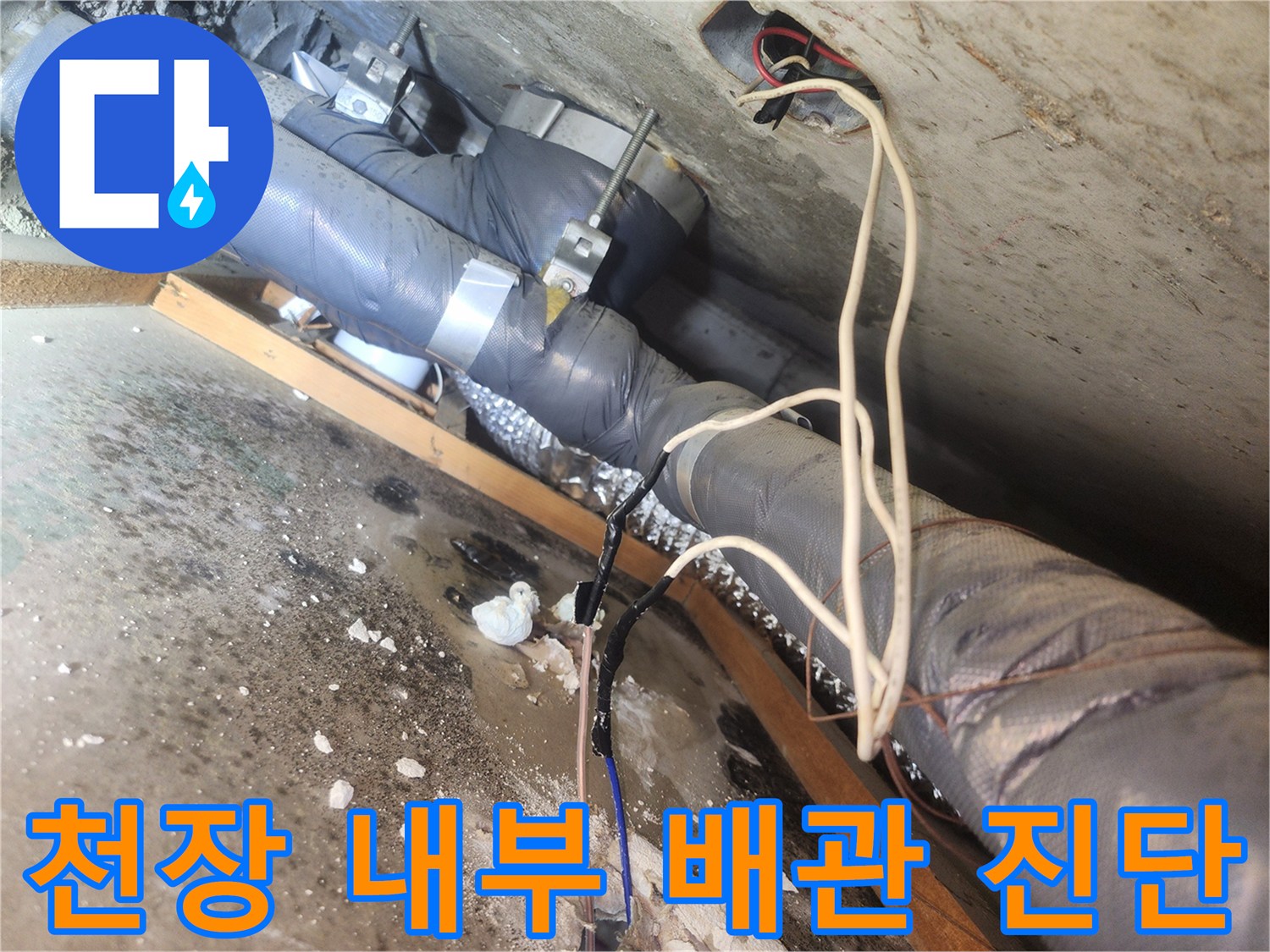 점검구를 통해 본 천장 내 하수관과 전기 배선 구조입니다.