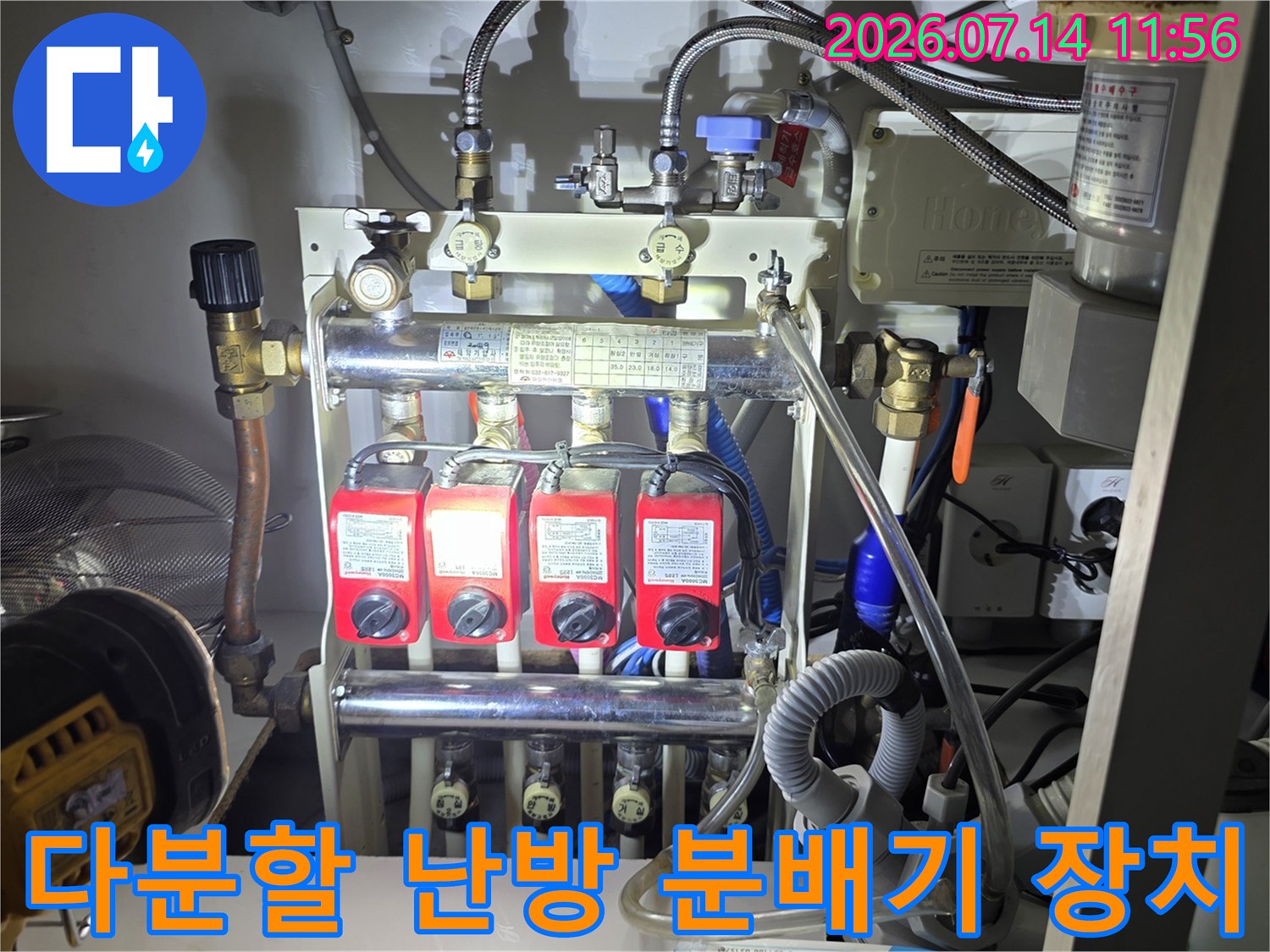 여러 개의-빨간색 밸브가 일렬로 배열된 금속제 보일러 분배기 시스템 사진