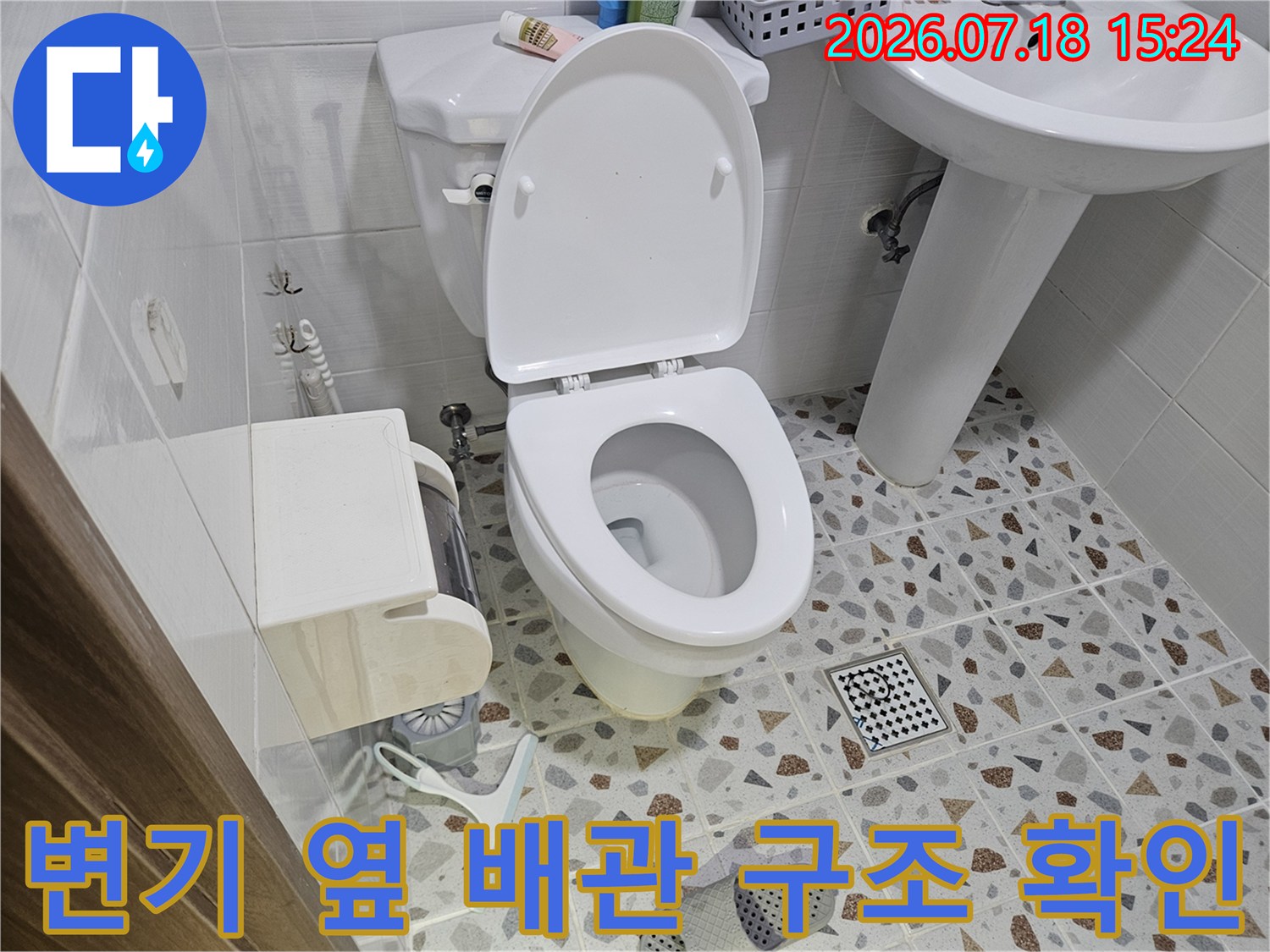 화장실 변기 주변에 노출된 하수관과 보온재로 감싸진 배관의 모습