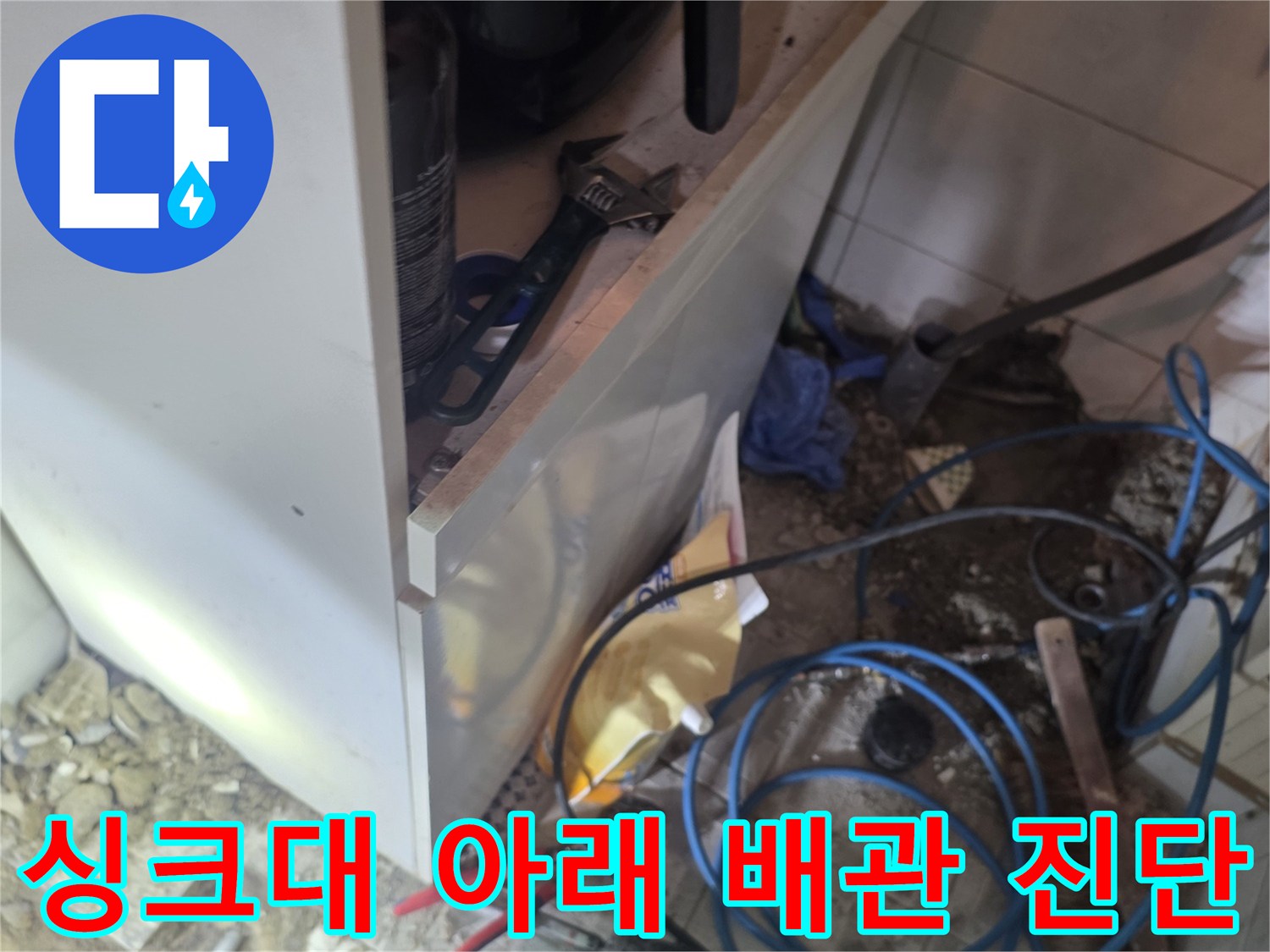 작업을 위해 정리된 싱크대 하단 배관과 장비들
