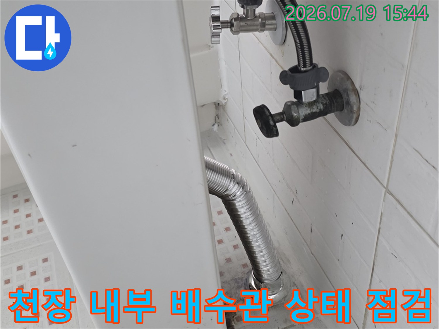 흰색-판넬-천장-속에-노출된-금속제-주름-배관과-고정장치