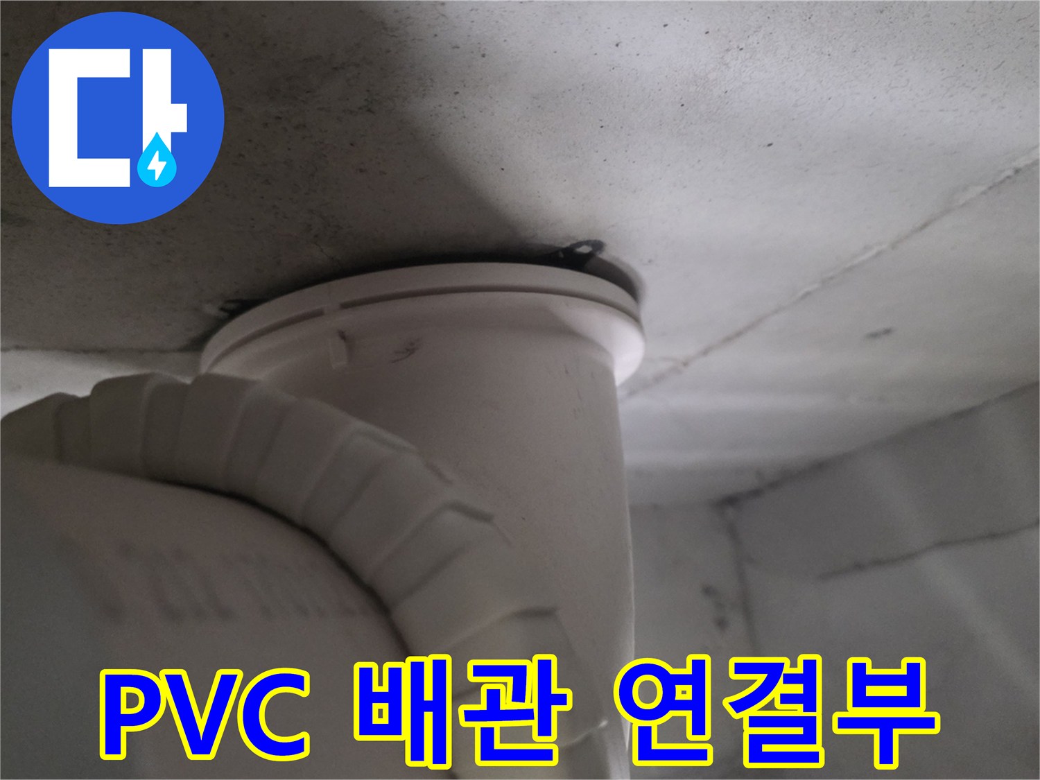천장 내부의 흰색 배관과 상부 콘크리트 구조물의 근접 촬영