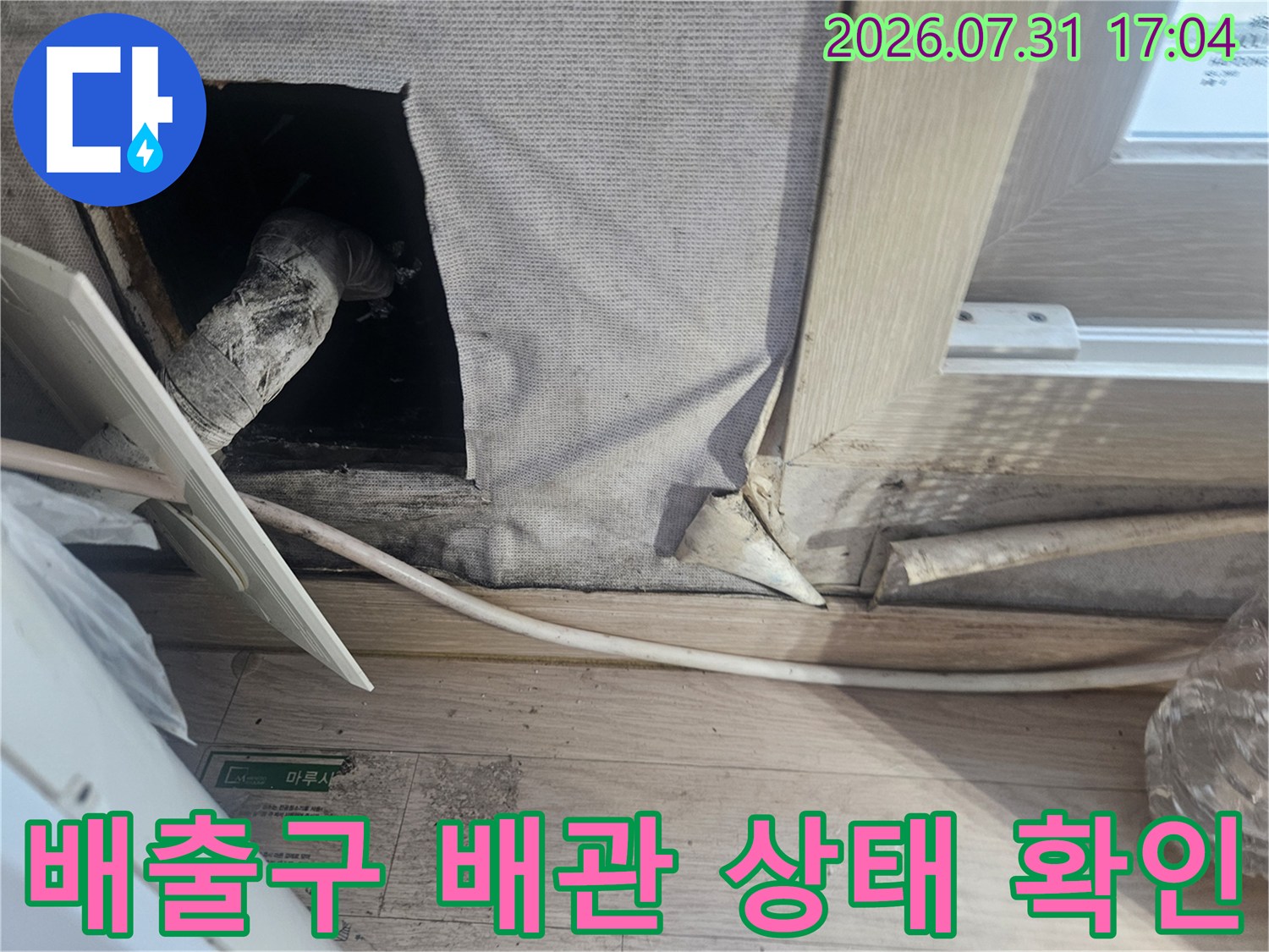 천장 내부를 통해 노출된 에어컨 드레인 호스의 수직 경로 점검