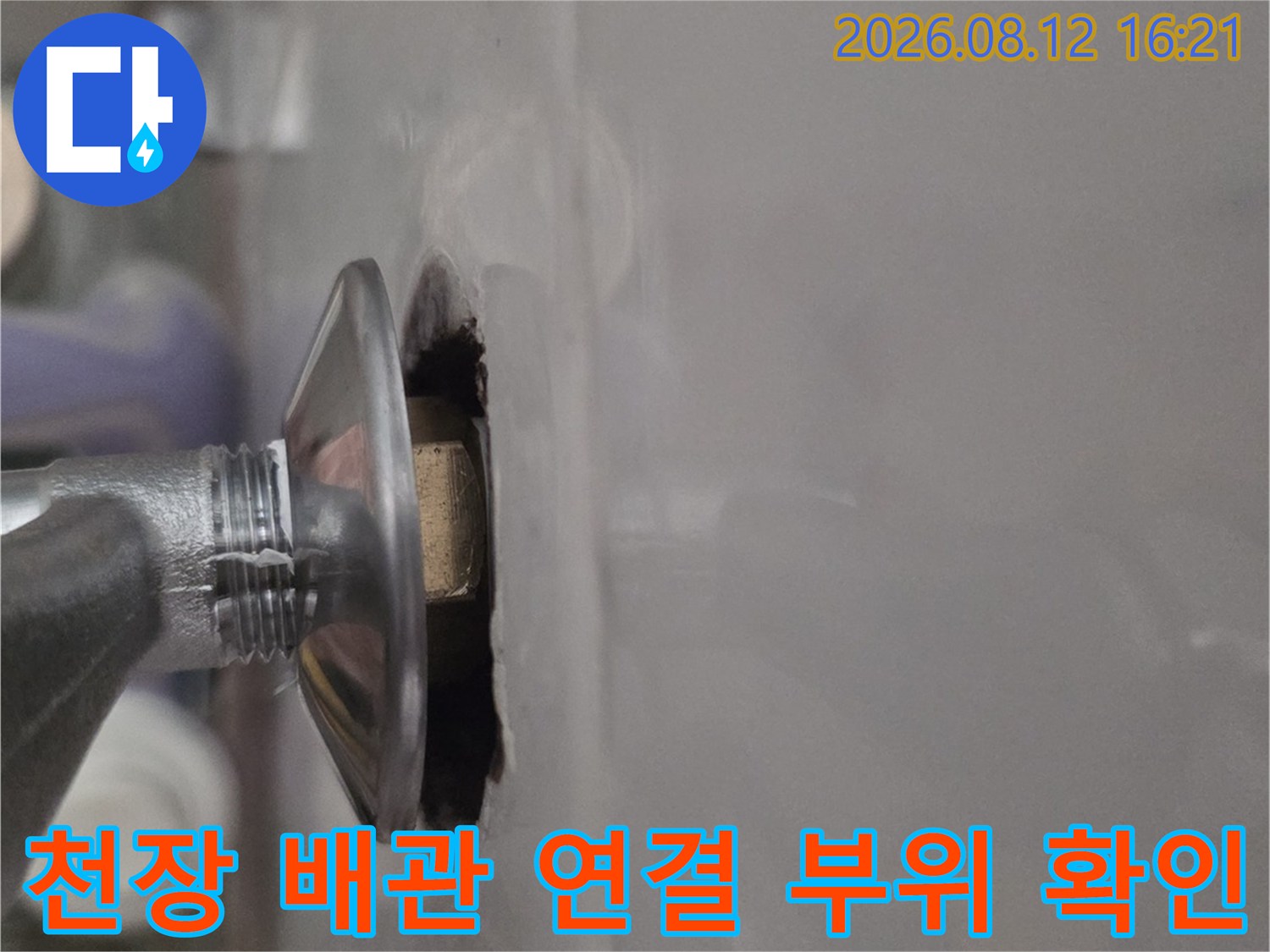 천장 마감재 사이로 노출된 금속제 배관 연결부-누수 지점 확인 모습