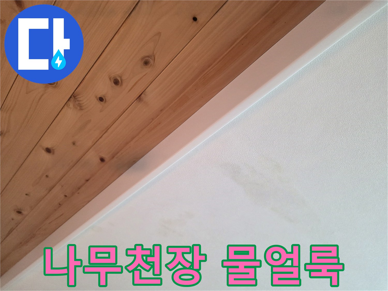 나무 소재의 천장과 흰색 벽면 경계에 나타난 물 얼룩 상태