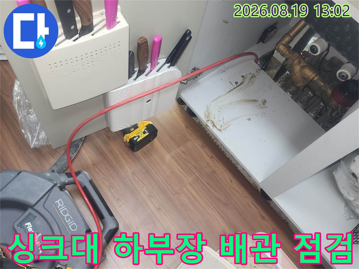 고양시 덕양구 화정동 싱크대 하부장 내부의 오염된 배관과 작업 장비 모습입니다.