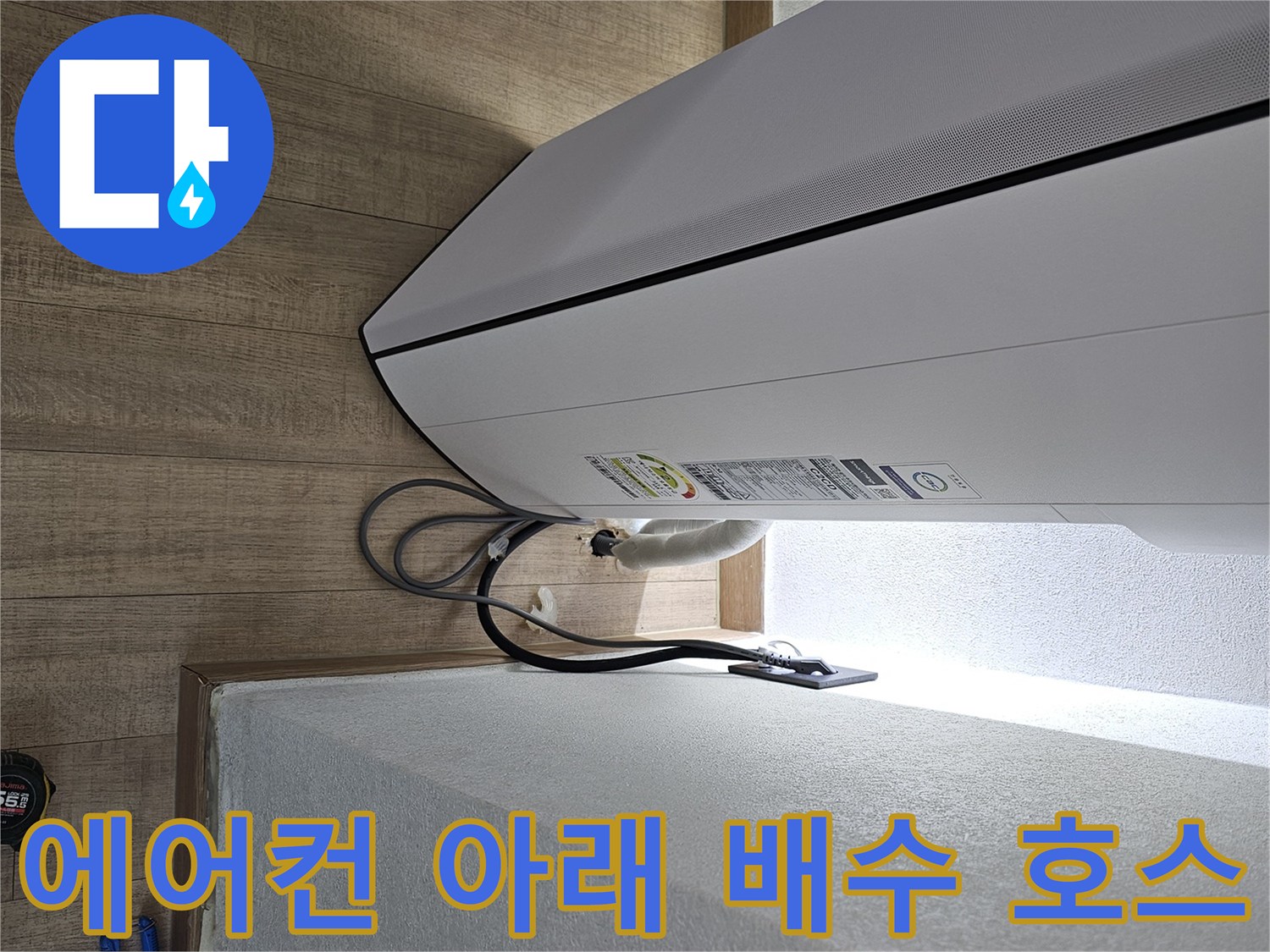 에어컨 본체 밑으로 연결된 하얀색 드레인 호스 사진