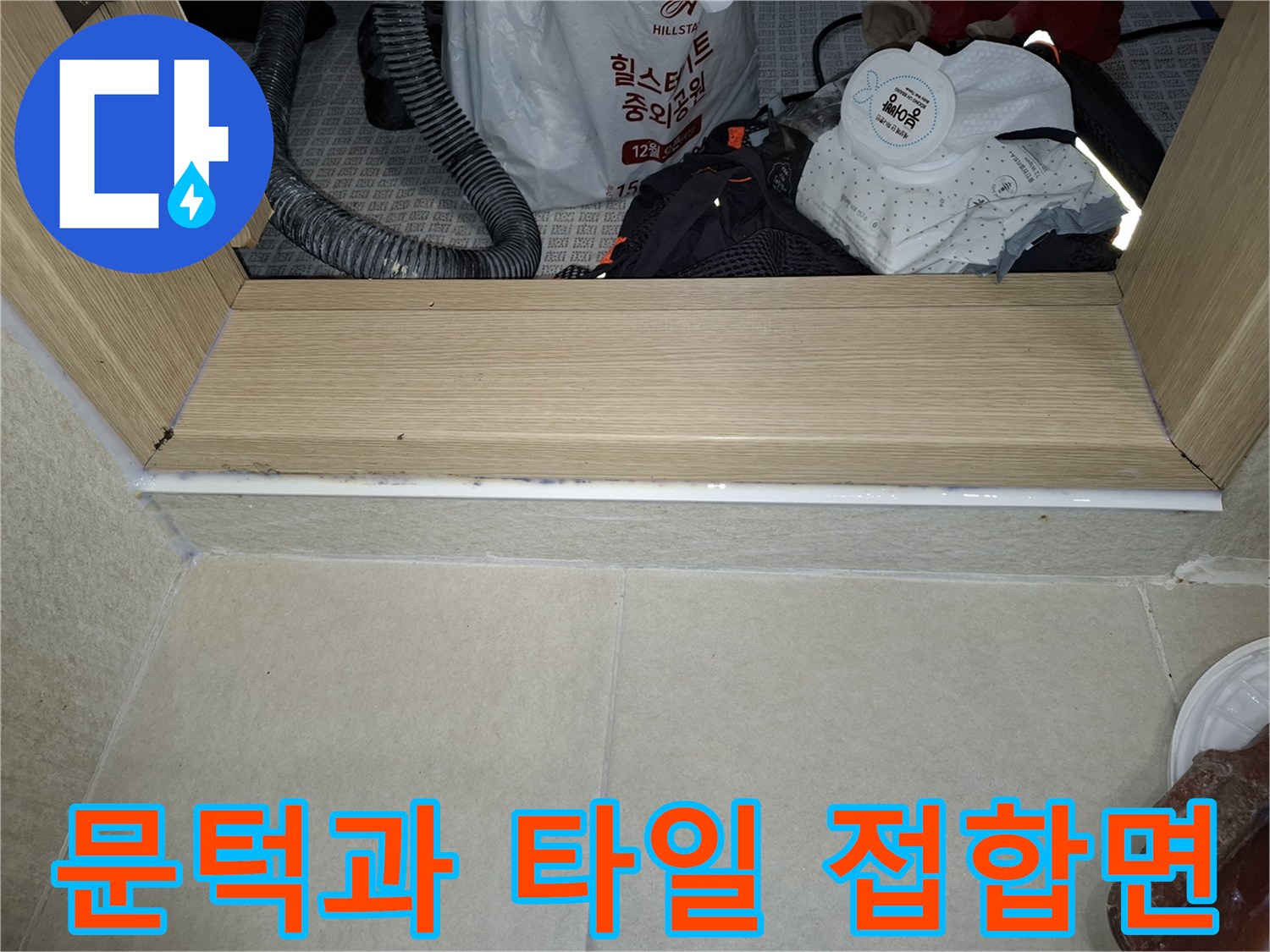 세탁실 입구 문턱 아래쪽 타일 경계 부위 촬영