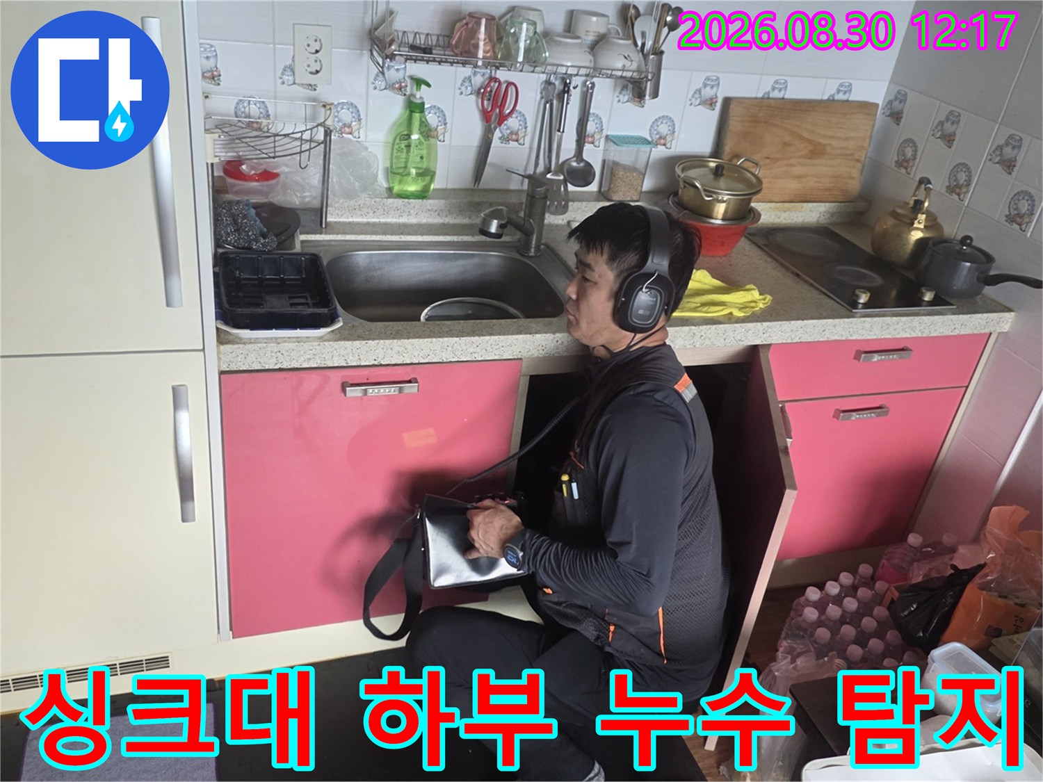 싱크대 배관의 누수 지점을 찾기 위해 청음기를 사용하고 있습니다.