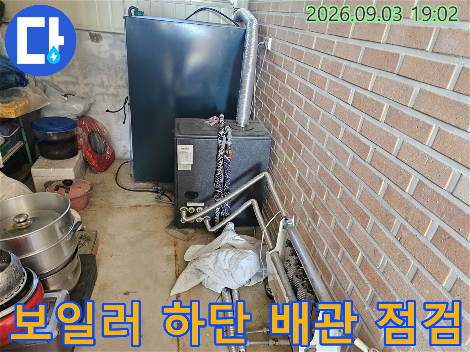 보일러 아래쪽으로 연결된 여러 갈래의 급수 및 온수 배관입니다.