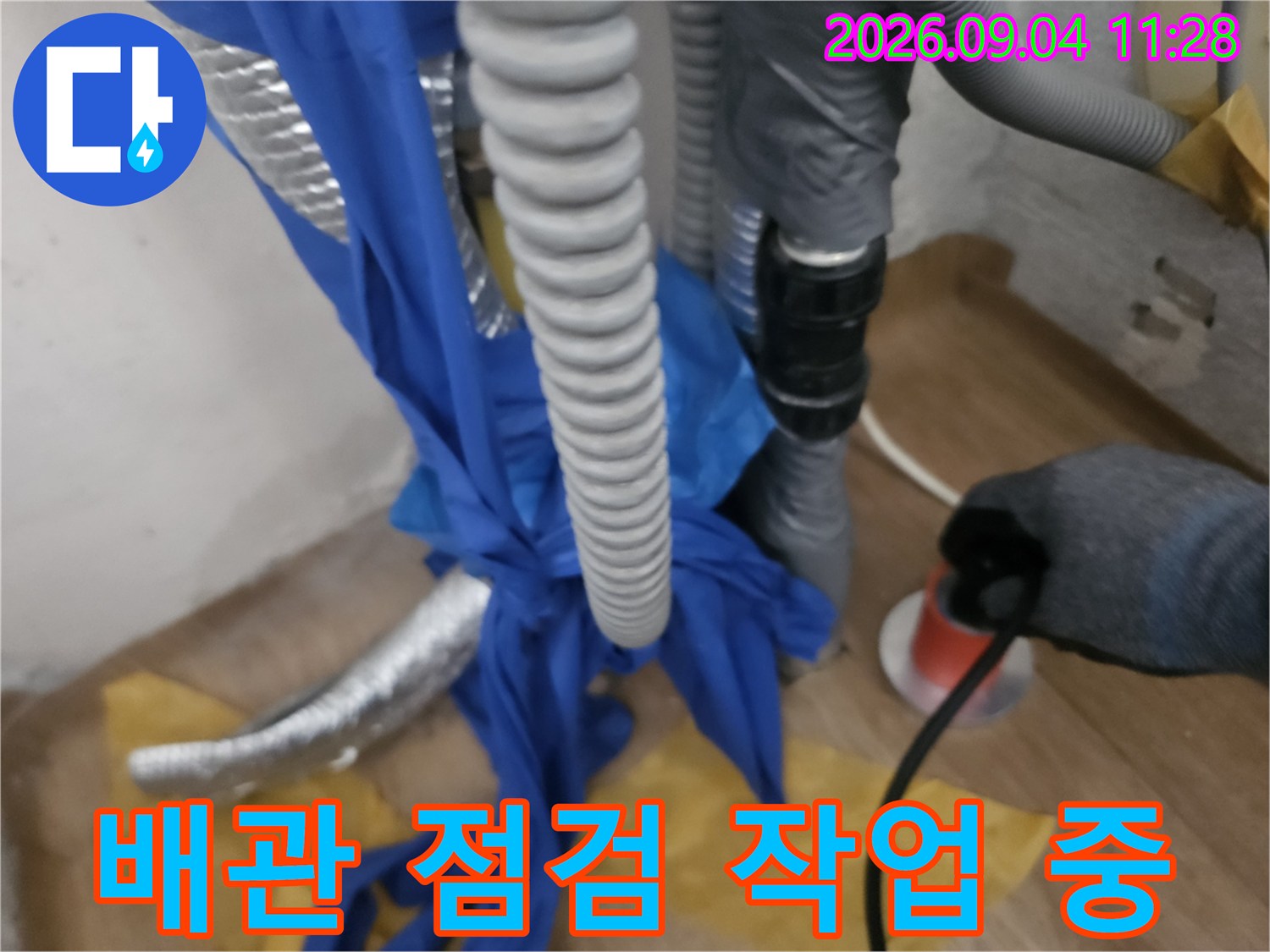 길음동 현장-누수 원인을 찾기 위해 배관에 장비를 연결한 모습입니다.