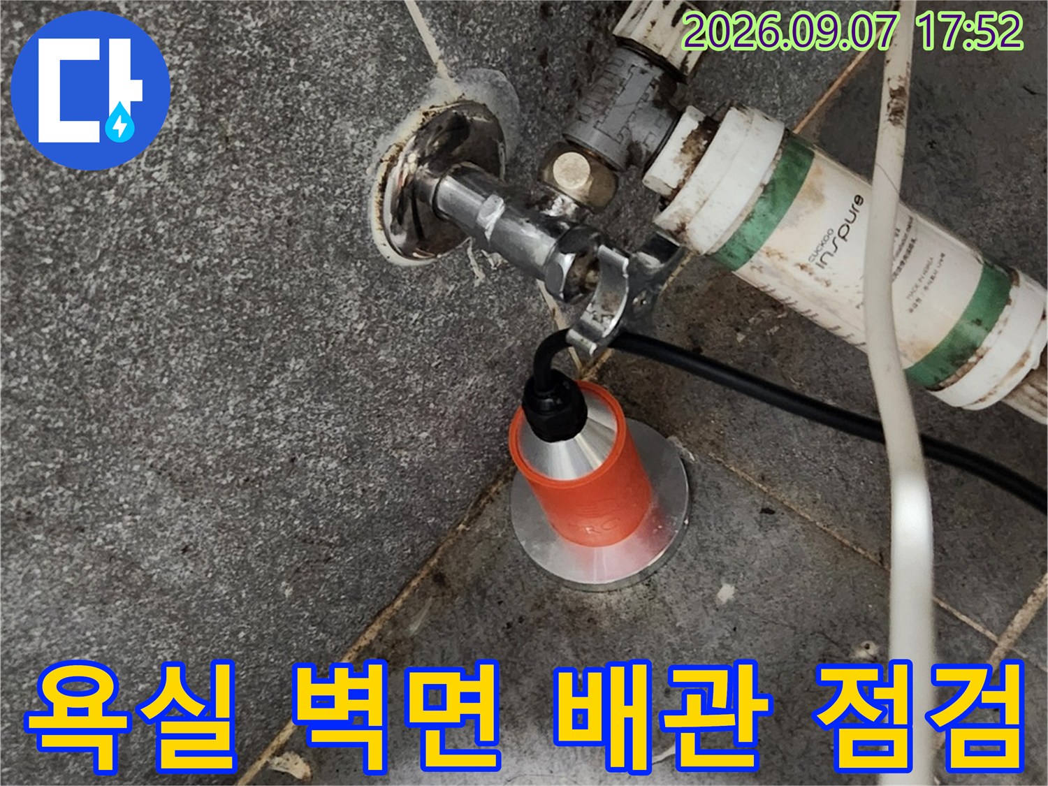 타일과 벽면 사이에 위치한 수도 부속의 노출 상태를 촬영했습니다.