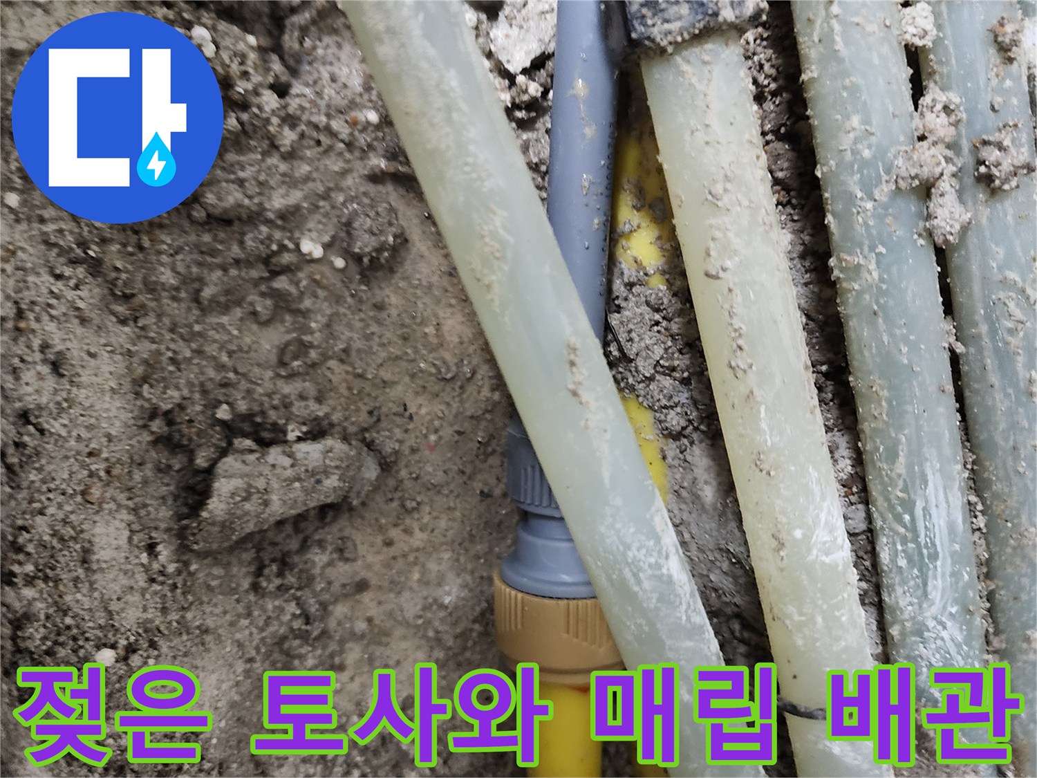 누수가 진행된 젖은 흙과 노란색 배관의 모습