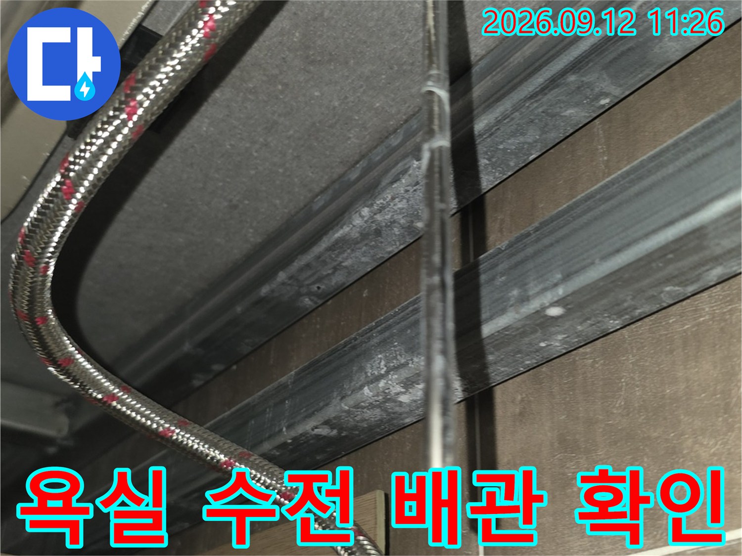 금속 재질의 유연한 급수 호스와 수전 밸브 연결 부위를 촬영하였습니다.