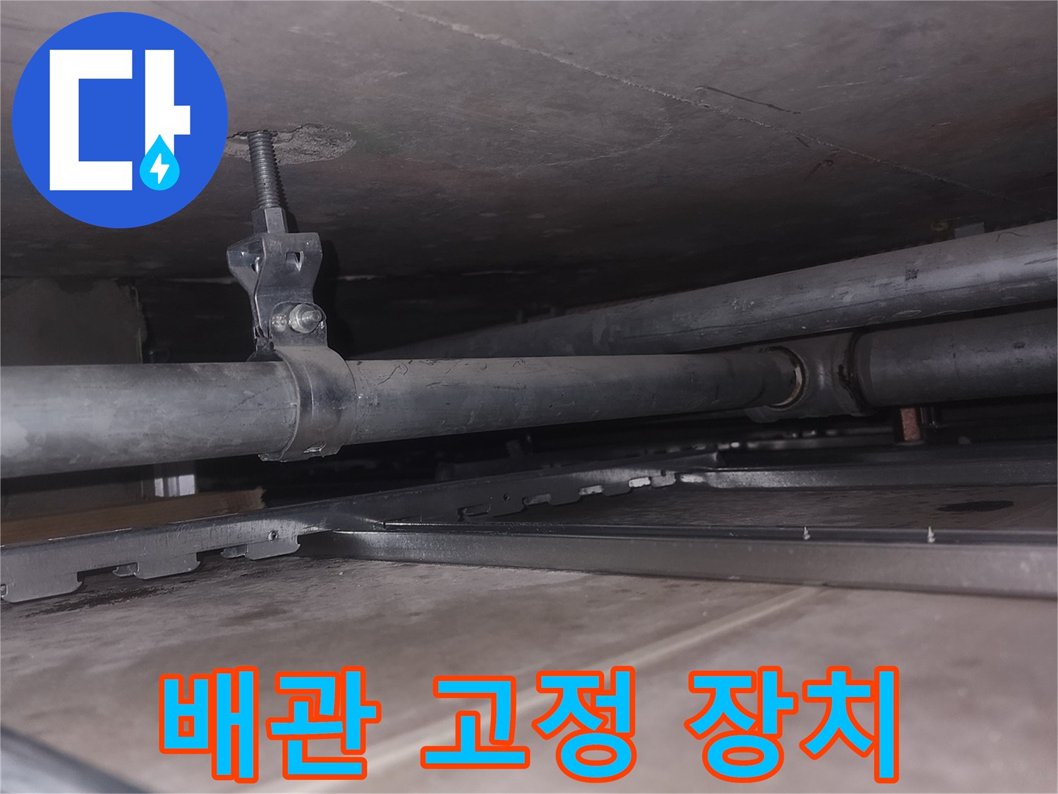 천장 배관을 지지하는 금속 브래킷과 배관 모습